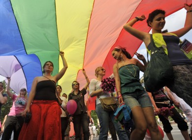Gay right activists march with a rainbow flag during the Gay Pride parade in downtown Budapest, Hungary, Saturday, June 18, 2011