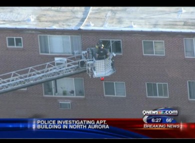 Police examine the gunman's apartment in North Aurora