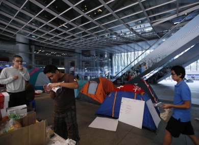 Occupy Hong Kong protestors serve snacks while sheltering under a canopy at HSBC's headquarters in the city.