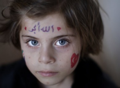Aya Abdulhay, 5, whose family fled their Aleppo home, takes refuge at the Bab Al-Salameh border crossing in hopes of entering one of the refugee camps in Turkey.