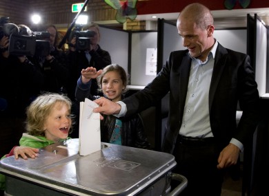 Labour Party PvdA leader Diederik Samsom casts his vote as his six-year-old son Fane, left, and eleven-year-old daughter Benthe, center rear, look on
