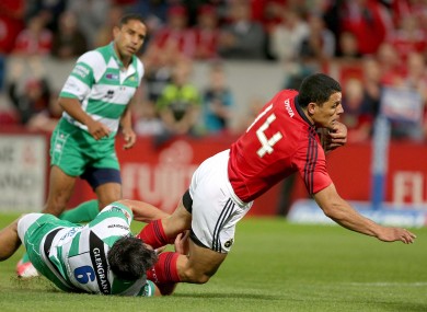 Munster's Doug Howlett scores the first try despite the attenions of Treviso's Simone Favaro.