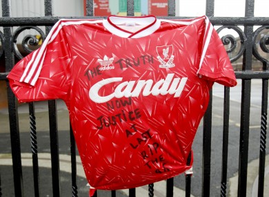 A replica of a previous Liverpool FC shirt is attached to the railings outside Anfield Stadium today.