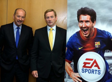 Enda Kenny with EA's chief operating officer Peter Moore - and a cardboard Lionel Messi - at the jobs announcement in Dublin today.