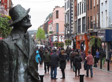A statue of author James Joyce overlooks the scattered shoppers on Dublin's North Earl Street.