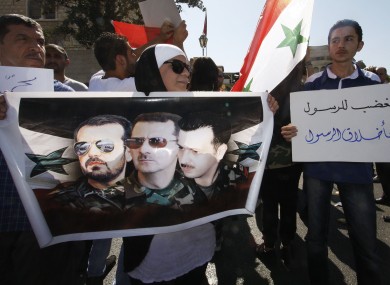 Pro-Assad supporters chant slogans during a demonstration in Damascus on Friday.