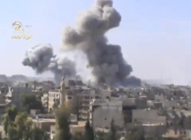 Image taken from video obtained from the Ugarit news network, shows smoke following heavy bombing in Deir el-Zour's Jbeileh neighborhood yesterday