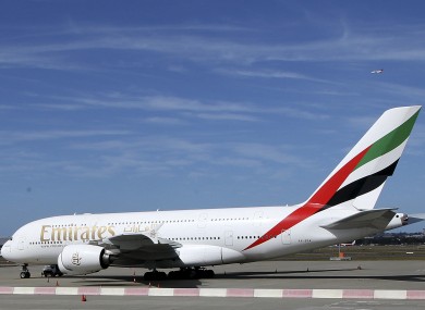 The Emirates A380 that suffered engine damage sits on the edge of the tarmac at Sydney international airport, Australia.
