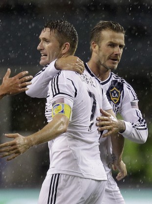 Los Angeles Galaxy's David Beckham and Robbie Keane celebrate.