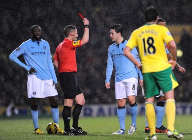 Manchester City's Samir Nasri (8) is sent off by match referee Mike Jones (second left)