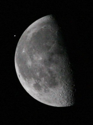 The International Space Station (ISS), upper left, passes the moon as viewed from the Kennedy Space Center, on 5 April, 2010, in Cape Canaveral.