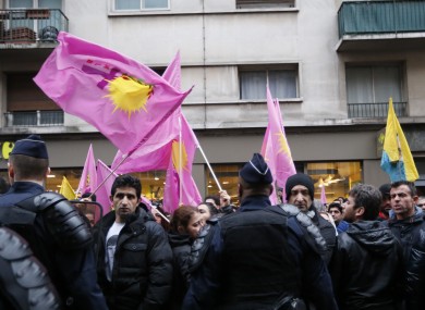 Kurdish activists gather outside a building where the three Kurdish women were shot dead, in Paris.