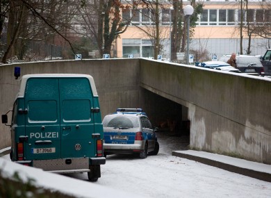 Police cars stand at the entrance of the underground parking lot where the entrace to the tunnel was located.