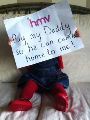 Kitty Mullane holds up a sign in support of her dad who is the assistant manager of the HMV store in Crescent Shopping Centre, Limerick.