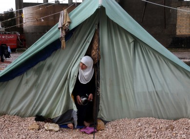 A Syrian refugee woman looks outside her tent, at a temporary refugee camp in the eastern Lebanese town of Marj near the border with Syria, Lebanon
