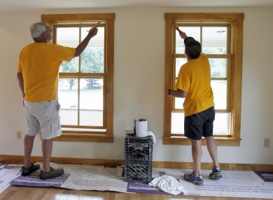 In this July 24, 2012 photo, volunteers Tony Lamb, left, and Ted Marcy work on a Tropical Storm Irene -damaged home