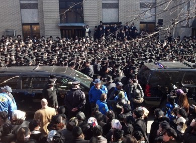 Crowds gather at a synagogue in Brooklyn where funeral services were held yesterday Nachman and Raizy Glauber.