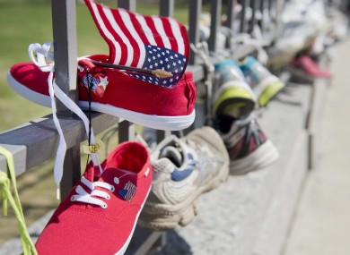 Running shoes, including one with an American flag, are tied to the gates of the American embassy in Ottawa after a march in solidarity with the Boston community in Ottawa, Canada.