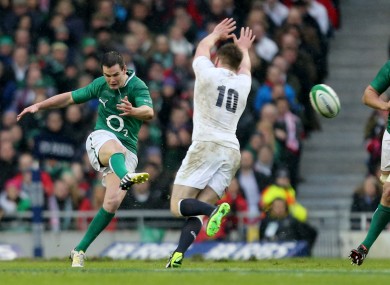 Owen Farrell tries to block a Jonathan Sexton kick.