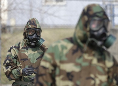Soldiers of the US Army 23rd chemical battalion wear gas masks while attending a demonstration of their equipment in South Korea today.