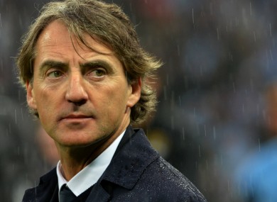 Manchester City manager Roberto Mancini appears dejected as he leaves the pitch following the FA Cup Final.