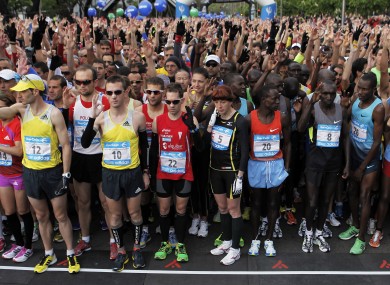Runners observe a moment of silence to honour Boston Marathon bombings victims as they take part in the 36th edition of the Madrid Marathon.