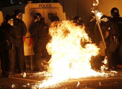 A petrol bomb hits riot police after it was thrown by loyalist rioters in the Woodvale area of north Belfast.