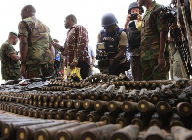 June 5, 2013 file photo, journalists look at arms and ammunition which military commanders say they seized from Islamic fighters, in Maiduguri, Nigeria.