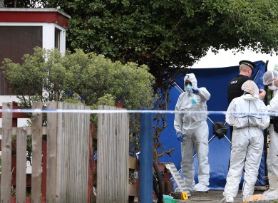 Police forensic officers working at the scene of a stabbing in Moston, Manchester.
