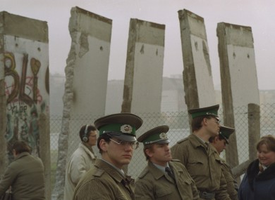 East German border guards in front of segments of the Berlin Wall towards the end of the Cold War