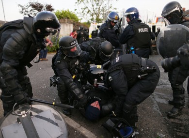 An injured PSNI officer helped by colleagues during July 12th riots.