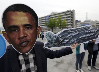 A protester wears a mask of Barack Obama during a protest at the US embassy in South Korea