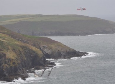 A Coast Guard helicopter hovers over the Astrid on 24 July