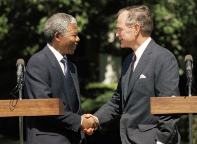 George HW Bush shaking hands with Nelson Mandela at the White House in 1990.