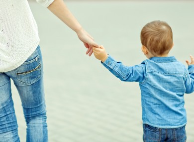 Holding a child's hand.