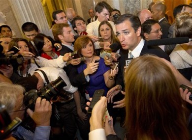 Ted Cruz speaks to the media after leaving a marathon speech on the Senate floor on Capitol Hill.