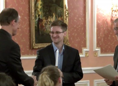 File: Former National Security Agency systems analyst Edward Snowden, center, receives the Sam Adams Award in Moscow