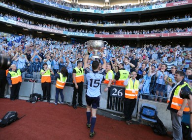 Dublin's Bernard Brogan lifts the Sam Maguire in front of supporters.