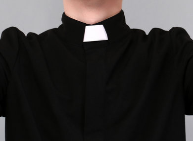 Priest on grey background