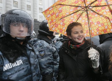An opposition supporter smiles during protest in front of the Ukrainian Cabinet of Ministers in Kiev today.