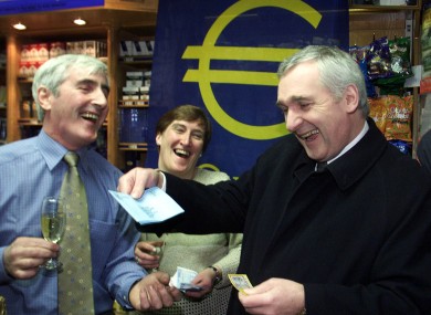 Then Taoiseach Bertie Ahern (right) celebrates the adoption of the Euro currency on the 1st of January 2002 with with Jim O'Neill and his wife Marian, proprietors of O'Neill's newsagents.