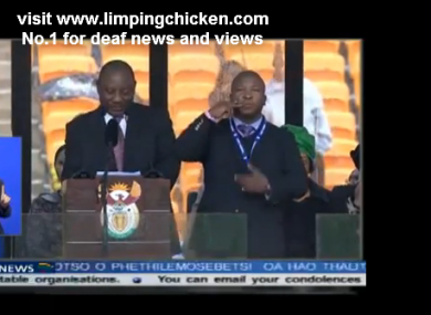 The 'fake' interpreter is the man in the main shot - not the woman with the blue screen behind her.