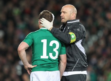 Dr Eanna Falvey treats Brian O'Driscoll for an injury in 2012.