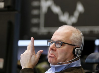 A trader makes a telephone call at the stock market in Frankfurt, Germany.