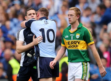 Kerry's Colm Cooper walks past Stephen Cluxton and Paul Flynn as they celebrate Dublin's win.