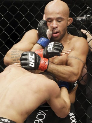 Demetrious Johnson, right, fights John Dodson during UFC flyweight championship bout earlier this year.