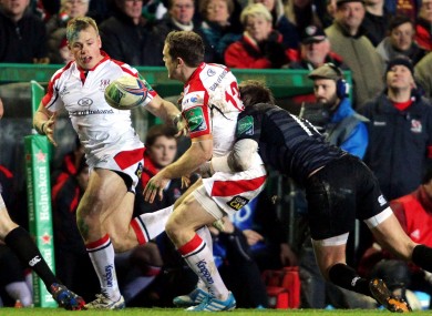 Darren Cave dishes the ball to Luke Marshall despite pressure from Toby Flood.
