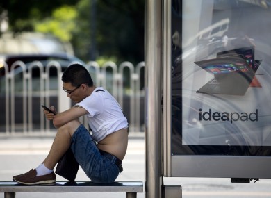A man checks his smartphone in Beijing.