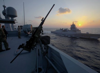 Danish warship Esbern Snare and Norwegian warship Helge Ingstad pass each other during a sunset at sea between Cyprus and Syria.