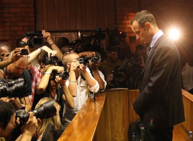 Oscar Pistorius faces the press from the dock.